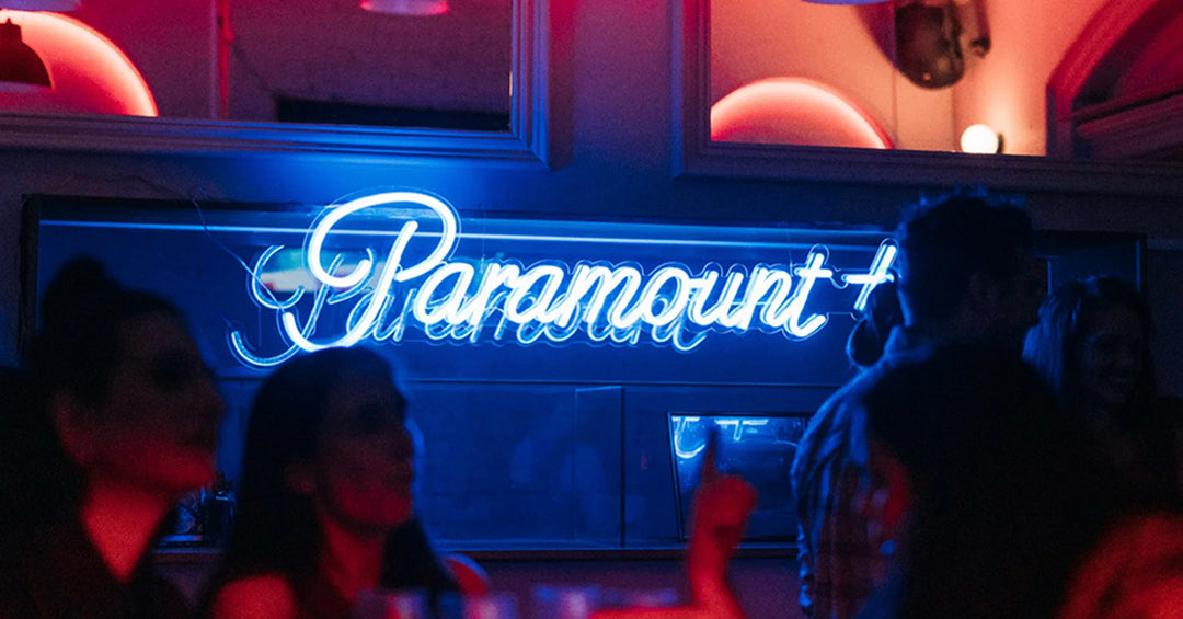 Paramount — blue neon script in bar setting